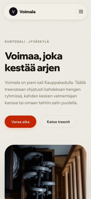 The Voimala Treenistudio front page on a phone: a bold headline above a photograph of gym weights.